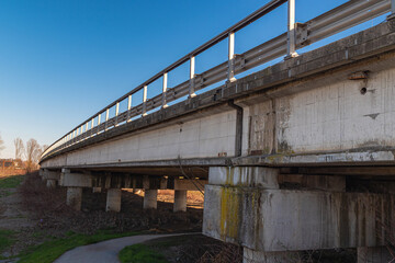 Fototapeta na wymiar Side View of a Long Road Viaduct Built in Reinforced Concrete with Guard rail