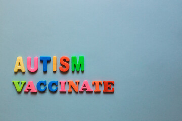 Autism, Vaccinate. The words are lined with letters from a plastic magnetic alphabet.