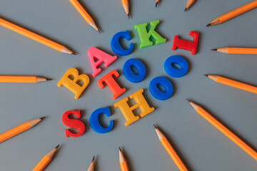 Back to school. Words laid out in letters with a magnet in the center of a circle of pencils