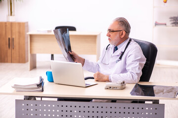 Fototapeta na wymiar Aged male doctor radiologist working in the clinic