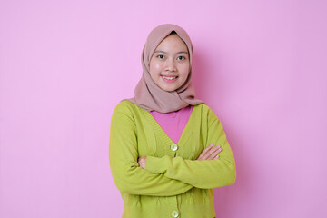 Standing Young Asian muslim woman wears headscarf smile with arms crossed