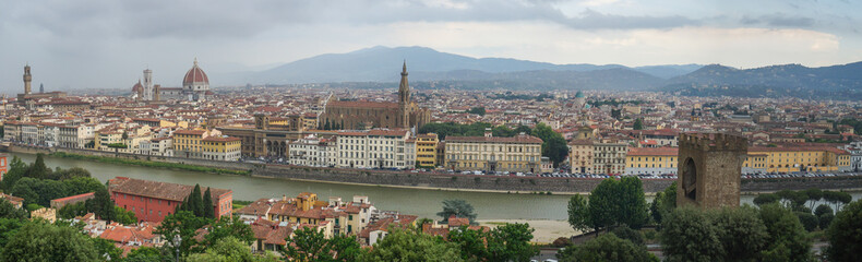 Fototapeta na wymiar Panorama of Florence. View of the Cathedral of Santa Maria del Fiore, the Basilica of Santa Croce, Palazzo Vecchio and the Arno River on a rainy day