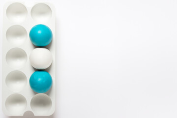 Simple minimalistic Easter greeting card with three Easter eggs in vertical plastic stand hold