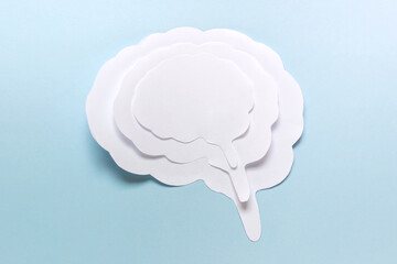 Simple paper concept with brain outline silhouette on blue background