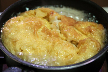 Crab omelette in heat oil for crispy on the outside ,soft on the inside omelette.