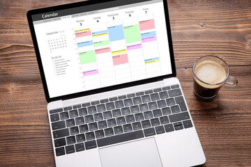 Laptop with calendar app on screen filled with different weekly appointments, meetings and tasks - obrazy, fototapety, plakaty