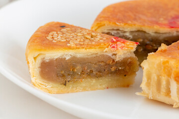 Traditional Teochew mooncake with savoury lotus paste containing preserved Chinese mustard green. Also known as 'la-pia' by Malaysian Chinese. Hand-crafted Mid-Autumn Festival pastry.