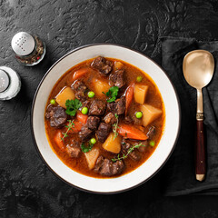 Irish stew made with beef, potatoes, carrots and herbs. Traditional St patrick's day dish. Black...