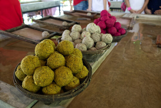 Elephant poo balls dyed in colors in baskets, waiting for students and travelers who interested in the processes of making elephant poo paper. Educational tour for sustainable living and development.