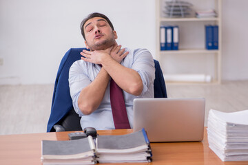 Fototapeta premium Young businessman and too much work in the office
