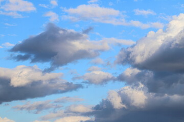 Naklejka na ściany i meble Rain gray clouds in the blue sky during the day. 
