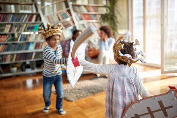 Kids are enjoying while playing with swords and shields at home. Family, together, love, playtime