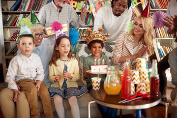 Family and friends having a good time at kids birthday party at home. Family, celebration, together