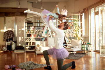 A young Dad and his little daughter have a ballet training at home together. Family, together, home