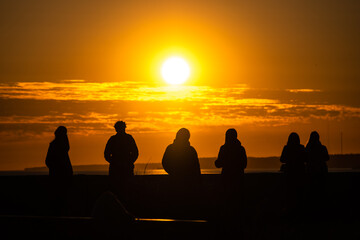 Group of people at sunset