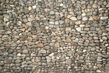 Texture and background wall gray stone part of the stone wall decorted a building.