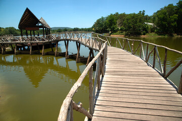 Wooden walkway bridge on the reservoir in the park Built for tourism in Thailand..