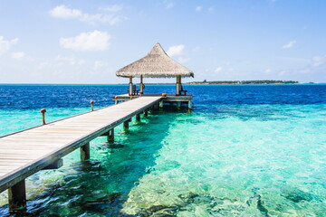 Wooden pier on a tropical beach in the Maldives