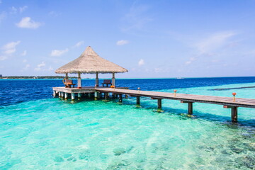 Wooden pier on a tropical beach in the Maldives