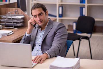 Young male employee working in the office