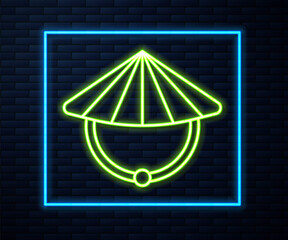 Glowing neon line Asian or Chinese conical straw hat icon isolated on brick wall background. Vector