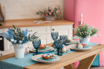 Easter served homemade table in the kitchen. Easster home decorations. pink and blue eggs