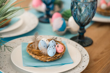 Easter served homemade table in the kitchen. Easster home decorations. pink and blue eggs