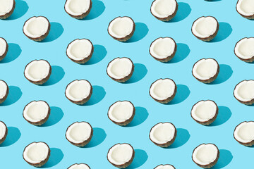 Pattern with ripe coconuts on blue background. Copy Space. Pop art design, creative summer concept. Banner. Half of coconut in minimal flat lay style