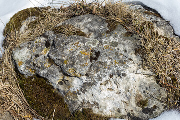 Natural mountain stone in a natural environment, rough surface burnt out in the sun and exposed to natural destruction.