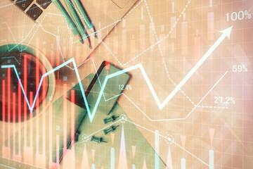 Double exposure of forex graph drawing over desktop background with computer. Concept of financial analysis. Top view.