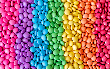 Vibrant sweet rainbow made of multi-colored round candies