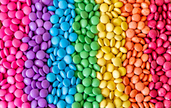 Vibrant sweet rainbow made of multi-colored round candies