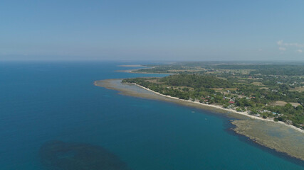Aerial view of seashore with beaches, lagoons and coral reefs. Philippines, Luzon. Coast ocean with turquoise water. Tropical landscape in Asia.