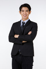 Portrait shot of Asian young black short hair happy rich ceo businessman office director in formal suit with necktie standing smiling cross arms at chest look at camera in front of white background