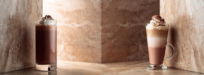 Milk coffee cocktail and chocolate milk on a beige ceramic background.