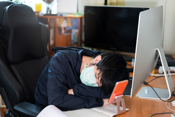 Adult asian business man wear face mask has sick and sleep in workplace.