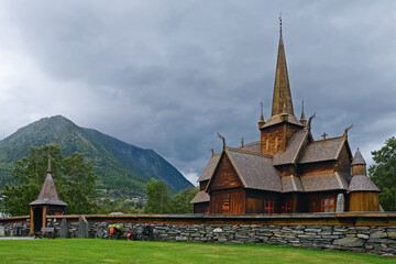 Fototapeta na wymiar View of medieval wooden stave church at cloudy day. Lom, Norway.