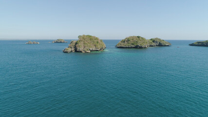 Naklejka premium Aerial view of Small islands with beaches and lagoons in Hundred Islands National Park, Pangasinan, Philippines. Famous tourist attraction, Alaminos.
