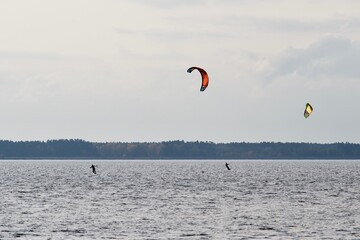 Two kite surfers at Lake Turawa in Poland on a cloudy day