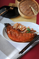 Dish of Char Siu Barbecue Pork on Red Background