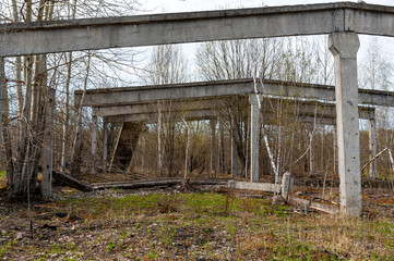 Old concrete ruins. The remains of the building. Old concrete pillars.