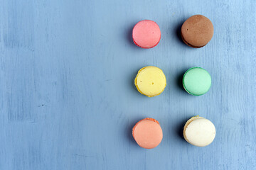 Flat lay of macarons on blue background