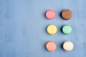 Flat lay of macarons on blue background