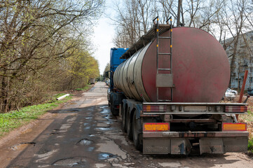 the truck is parked on the side of the road. truck rear view. tank trailer