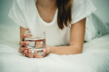 a glass of water in hands close-up