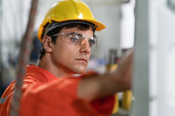 Male engineer checking robotic arm machine for system welding at a factory Industrial