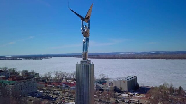 Monument of Glory in Samara city, aerial view at sunny weather, flying around statue