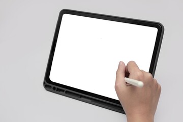 Woman’s right hand using stylus pen on tablet, isolated on white with copy space on the tablet