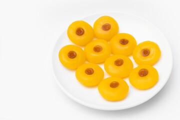 Kanom Sanay Chan, traditional sweet dessert originating in Thailand - Nutmeg –like yellow sweetmeats, serving on white plate isolated on white