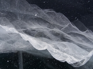 unique natural drawings on the ice of Lake Baikal similar to space. Winter in Siberia Russia